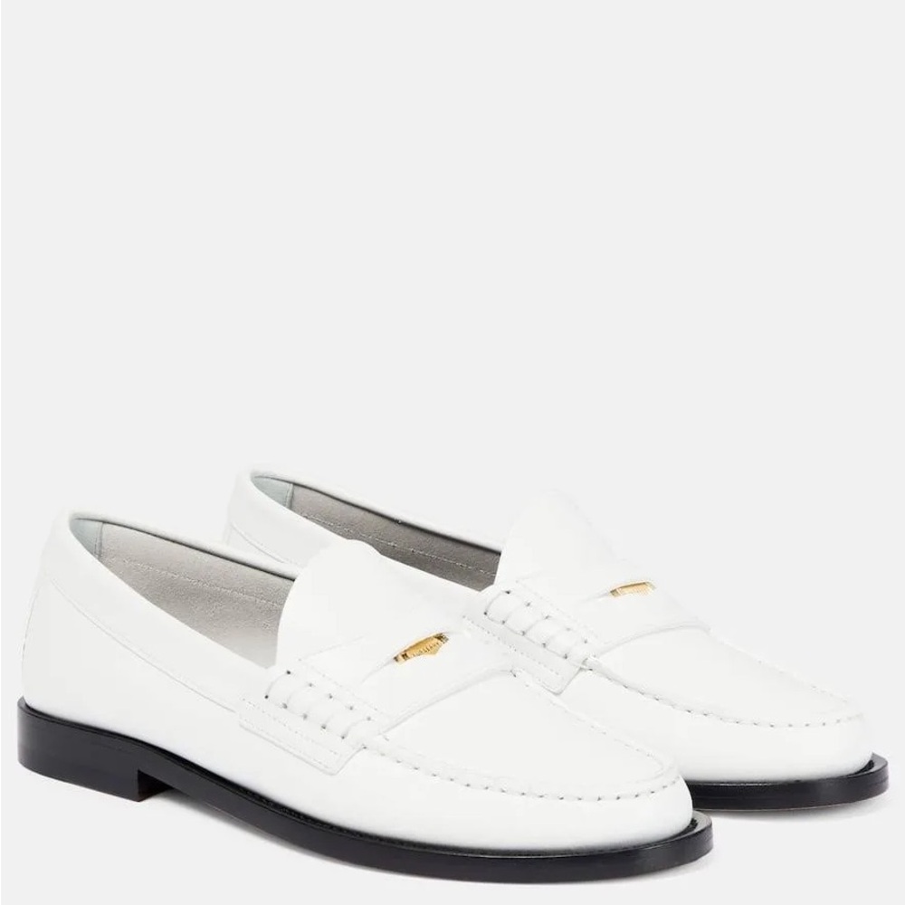 Burberry
Burberry Logo-Detailed Slip-On Penny Loafers with coin detail.